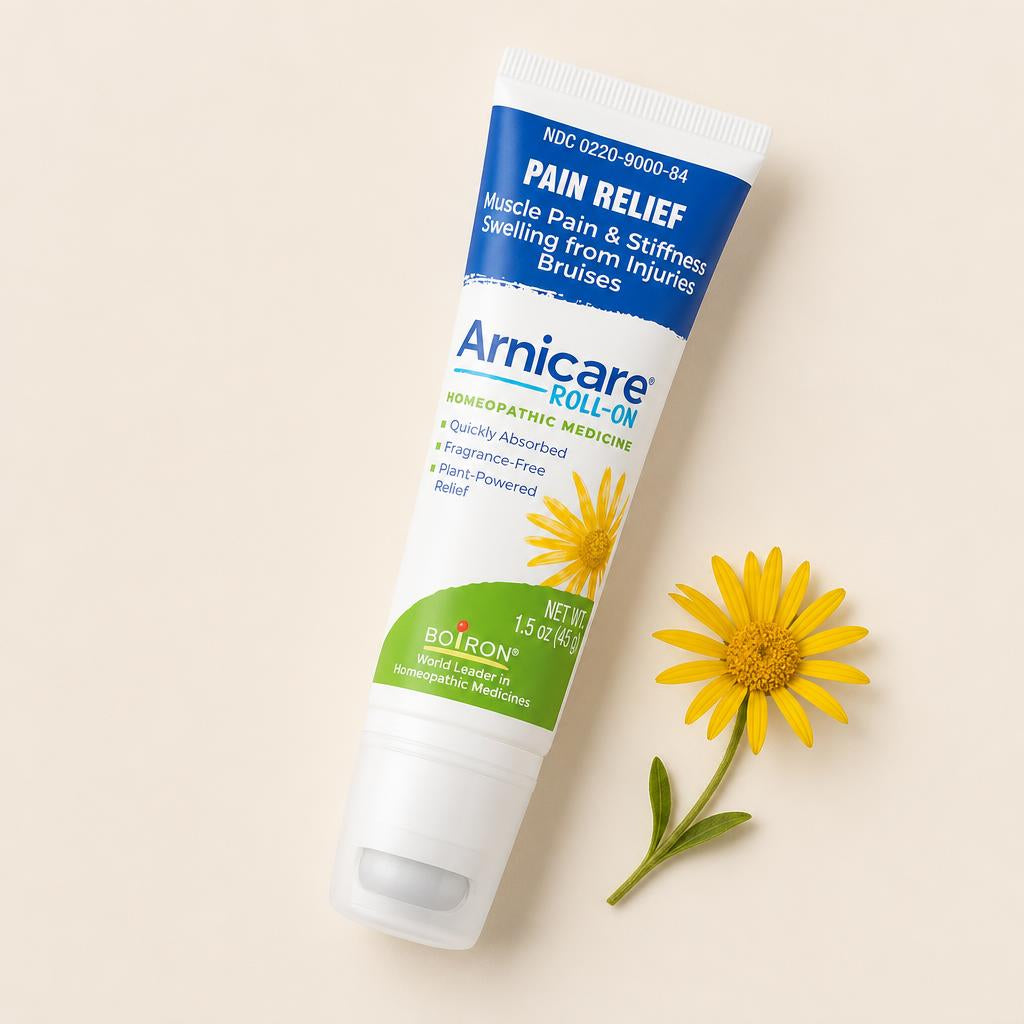 Boiron Arnicare Roll-On with arnica flower flat lay